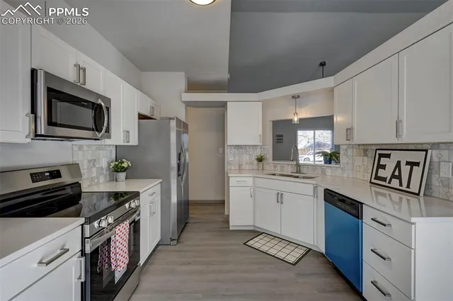 a kitchen with granite countertop cabinets stainless steel appliances and a counter space