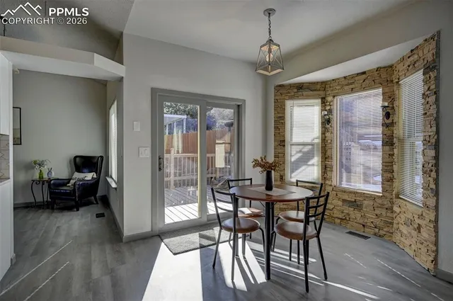 a view of a dining room with furniture window and wooden floor