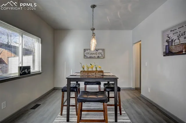 a view of a dining room with furniture window and wooden floor