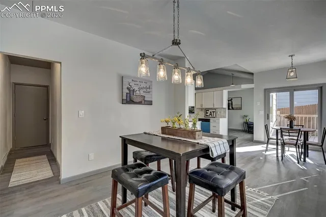 a view of a dining room with furniture and wooden floor