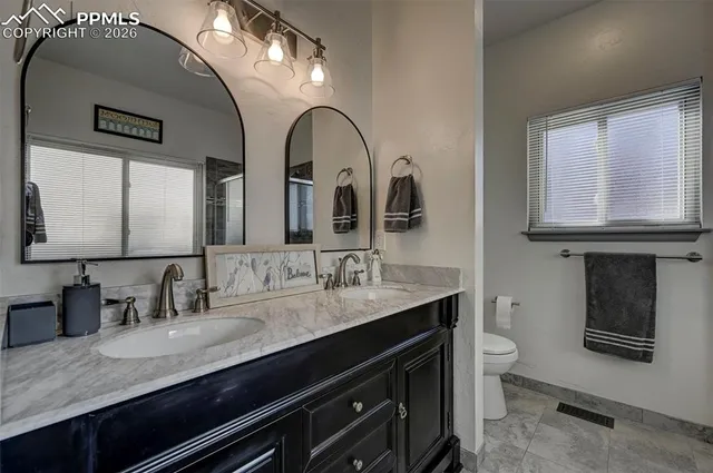 a bathroom with 2 sink and a mirror