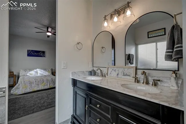 a bathroom with a double vanity sink and a mirror