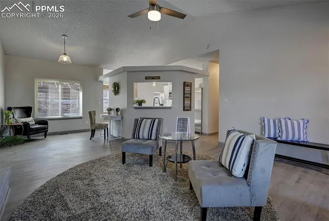 a living room with furniture and wooden floor