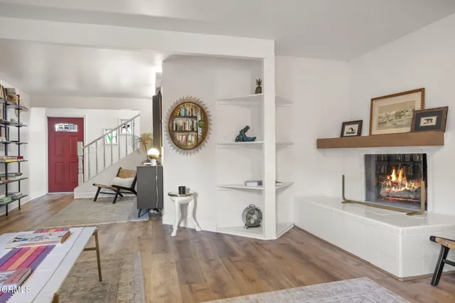 a living room with furniture and a book shelf