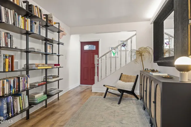a living room with furniture a fireplace and lots of windows