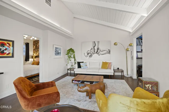 a living room with furniture and a potted plant