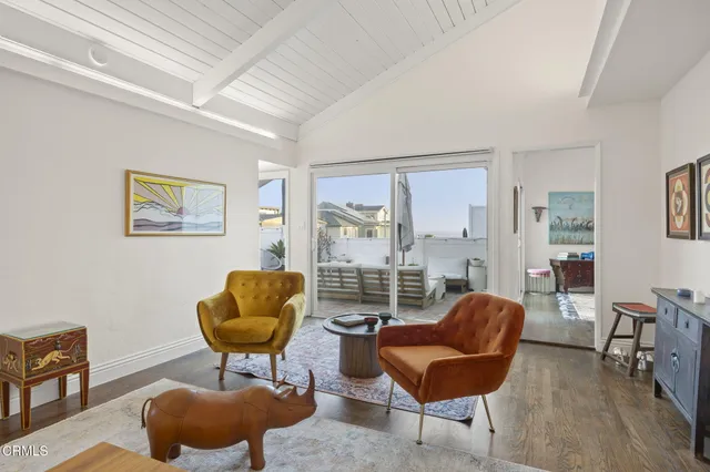 a living room with furniture and a glass door
