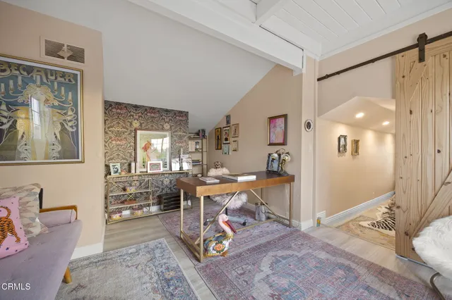 a living room with furniture a table and a large window