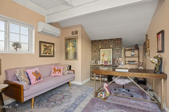 a bedroom with a bed and painting on the wall