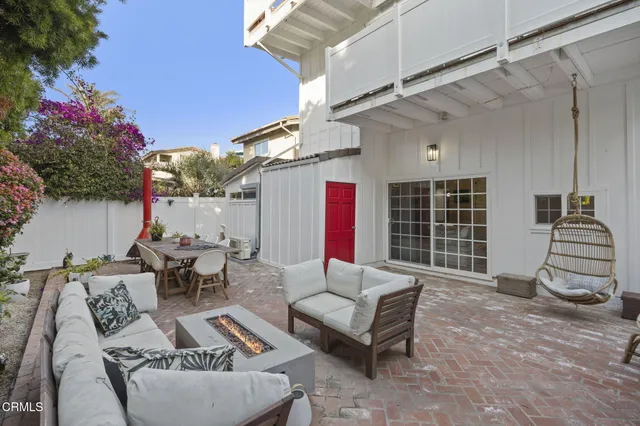 a view of a dining table and chairs in the patio