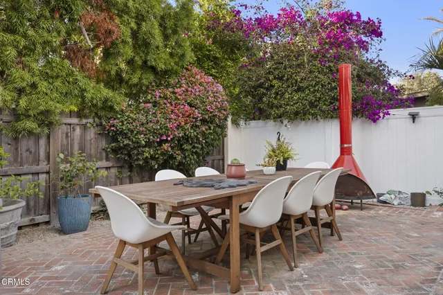 a very nice looking room with a large window and potted plants