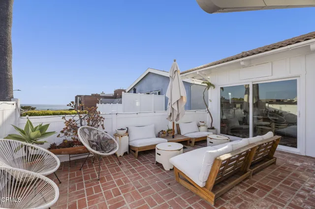 a view of balcony with wooden floor and seating space