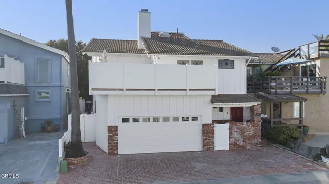 a bedroom with a bed couch and a large window