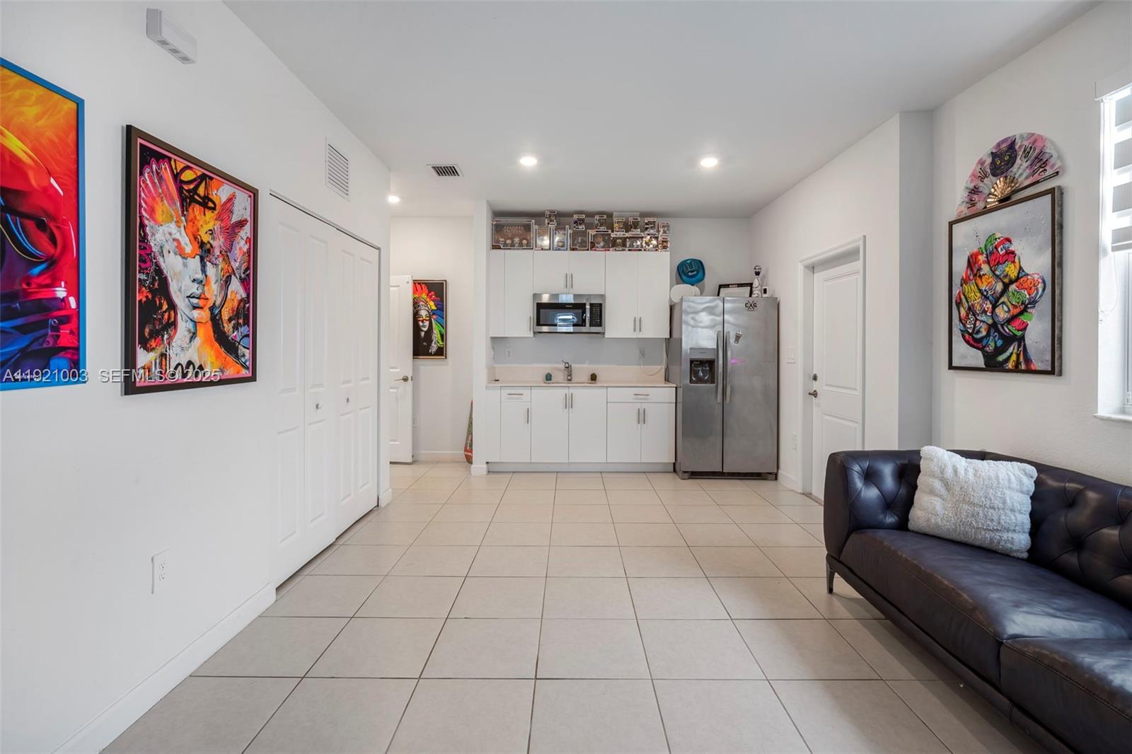 21189 Southwest 127th Court Miami, FL 33177 - Photo 19 of 46 a living room with furniture and kitchen view