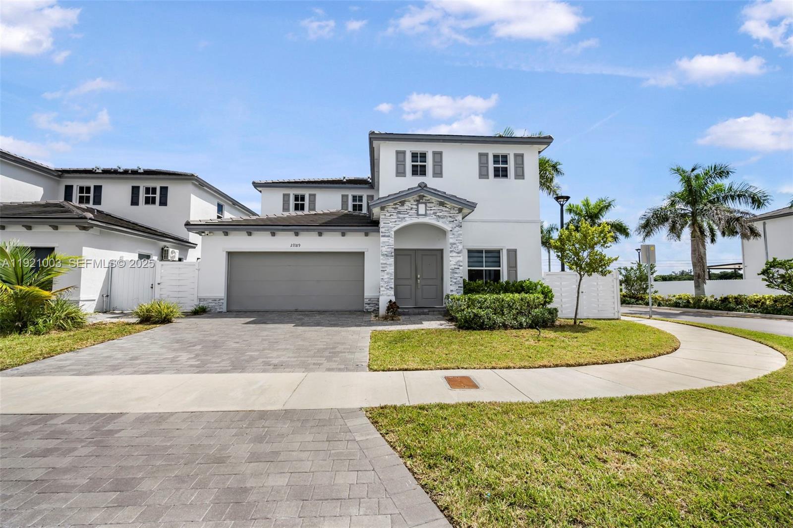 21189 Southwest 127th Court Miami, FL 33177 - Photo 2 of 46 a front view of a house with a yard and garage
