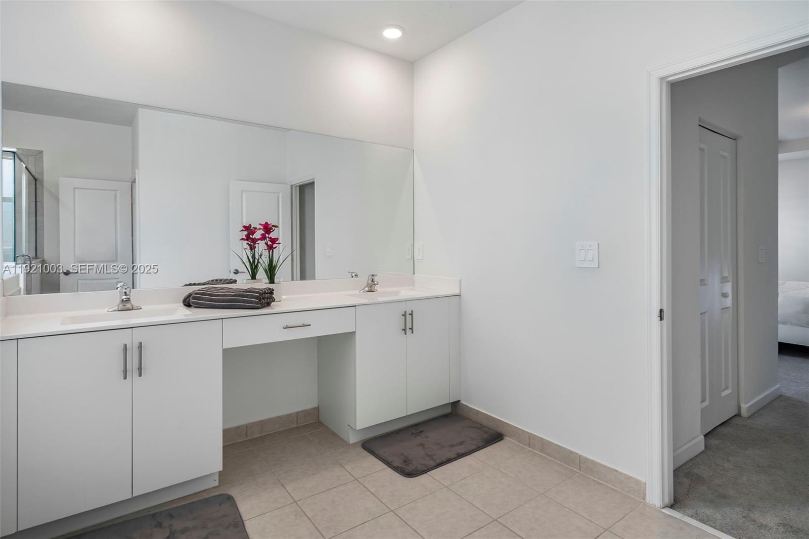 21189 Southwest 127th Court Miami, FL 33177 - Photo 26 of 46 a bathroom with a sink and a mirror