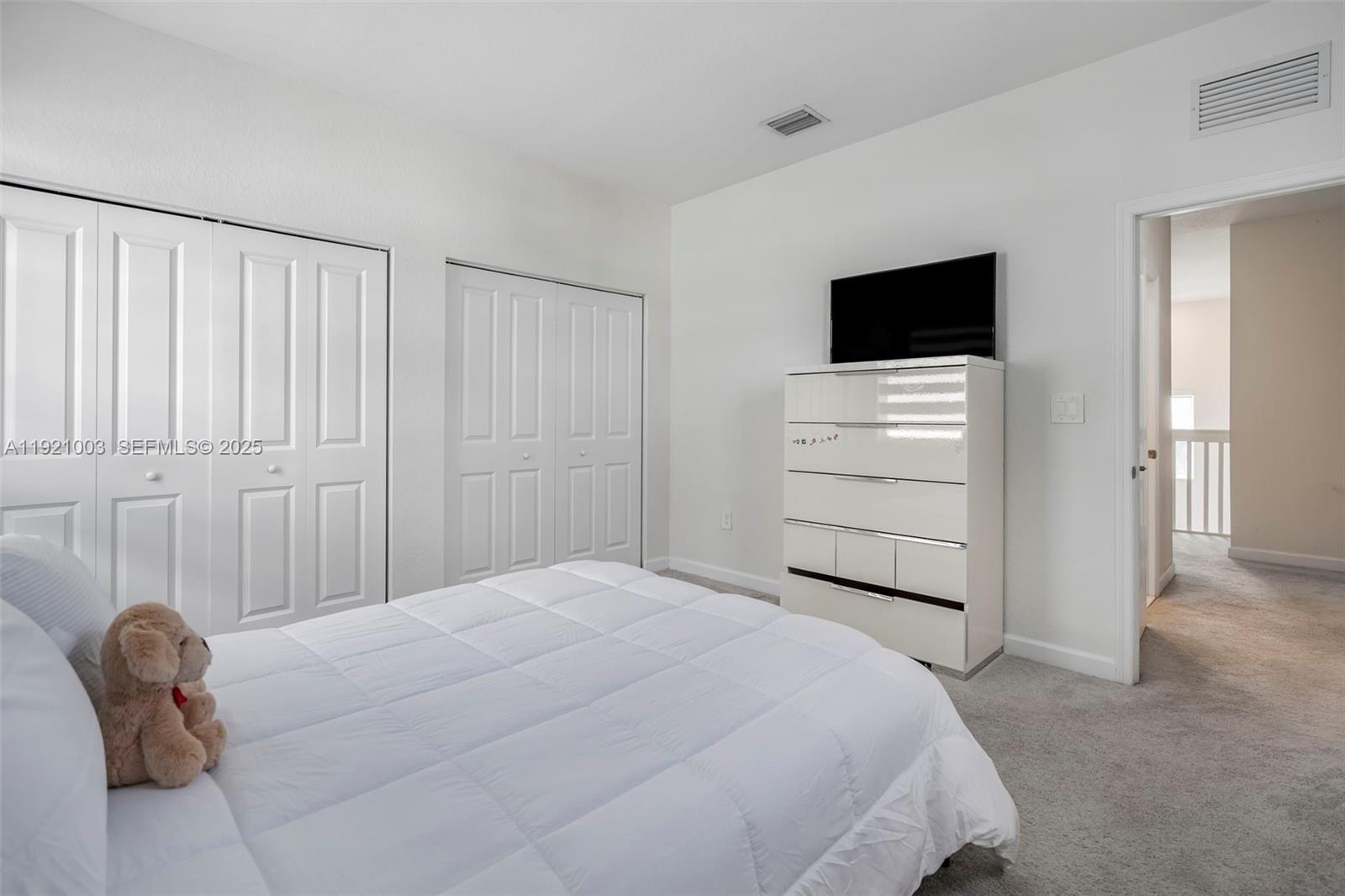 21189 Southwest 127th Court Miami, FL 33177 - Photo 33 of 46 a bedroom with a bed and chair