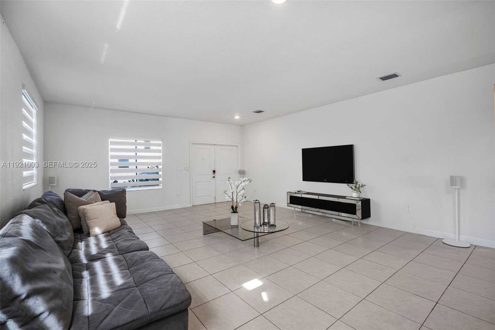 21189 Southwest 127th Court Miami, FL 33177 - Photo 5 of 46 a living room with furniture and a flat screen tv