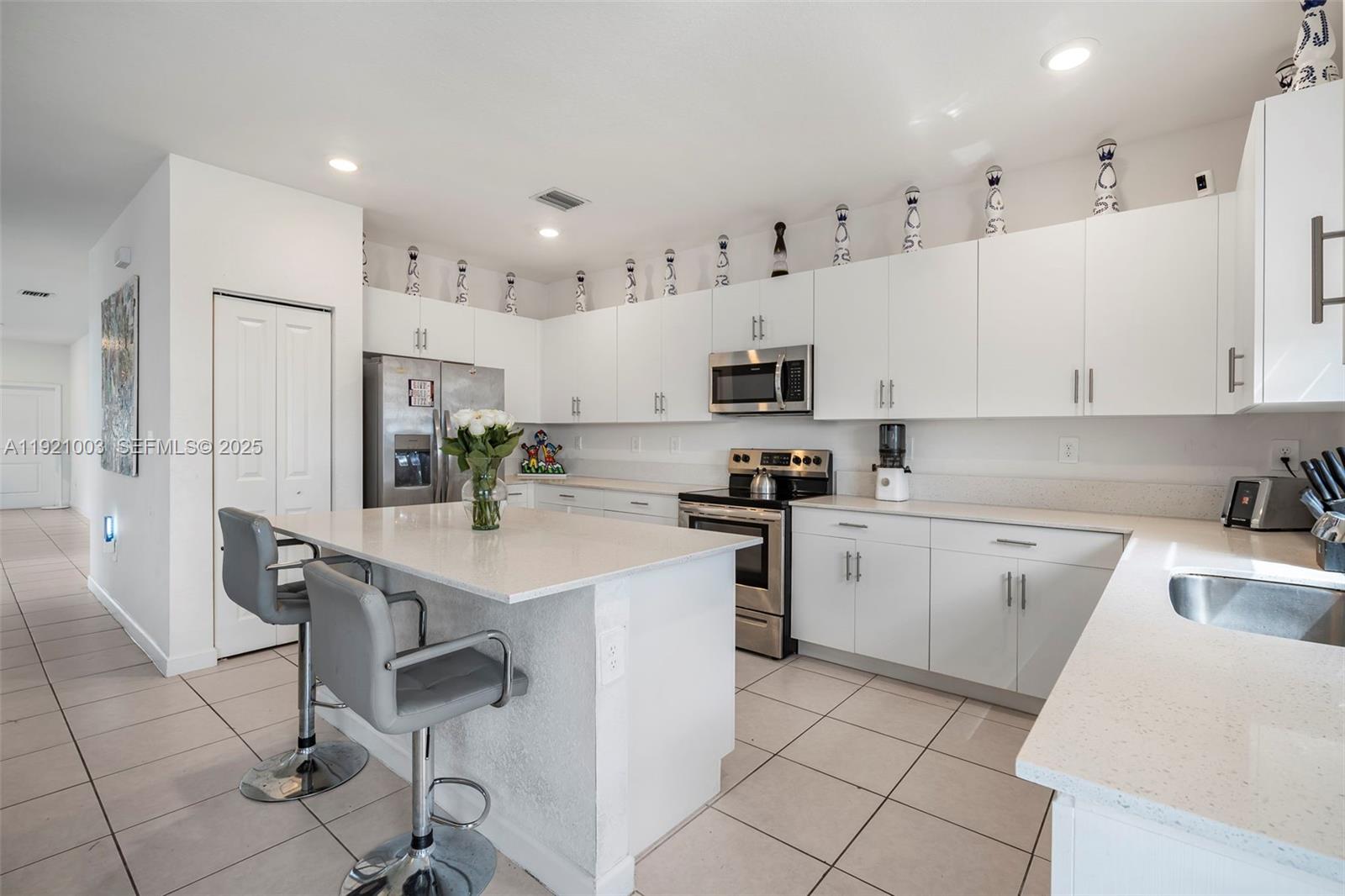 21189 Southwest 127th Court Miami, FL 33177 - Photo 8 of 46 a kitchen with cabinets and chairs