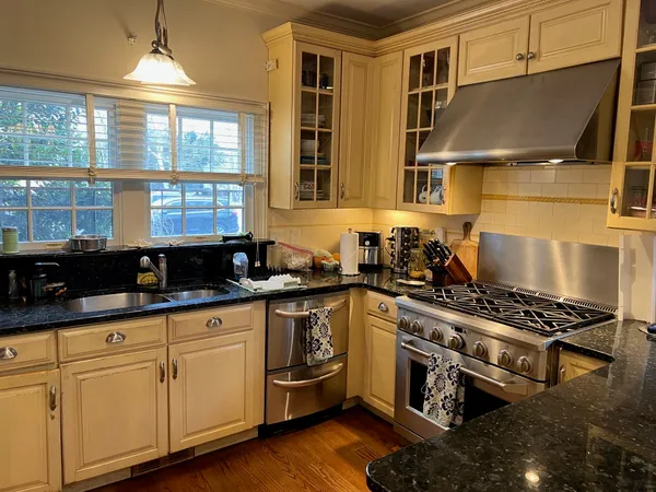 a kitchen with granite countertop a stove and a sink