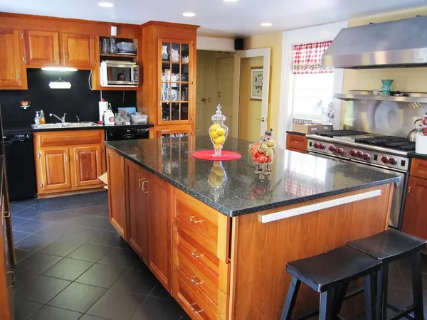 a kitchen with stainless steel appliances granite countertop a sink counter space and stove top oven