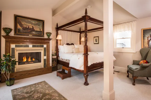 a bedroom with furniture and a fireplace