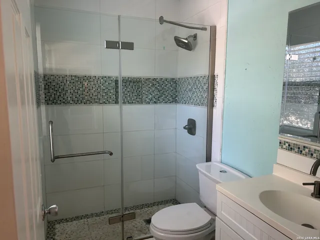 a white toilet sitting next to a bathroom sink