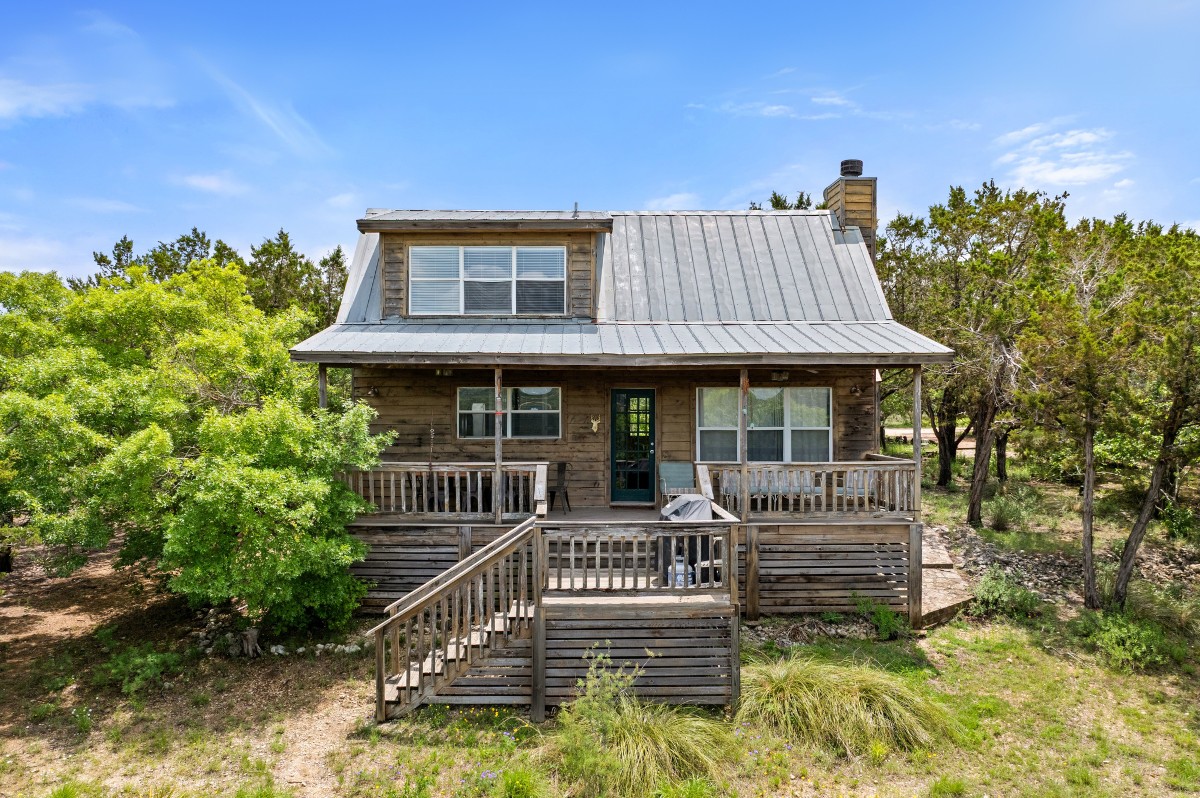 17 September Ridge Johnson City, TX 78636 - Photo 19 of 40 Back of house featuring a chimney, stairway, metal roof, and covered porch