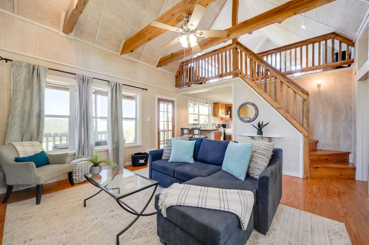 17 September Ridge Johnson City, TX 78636 - Photo 8 of 40 Living room featuring stairs, wood finished floors, beam ceiling, high vaulted ceiling, and a ceiling fan