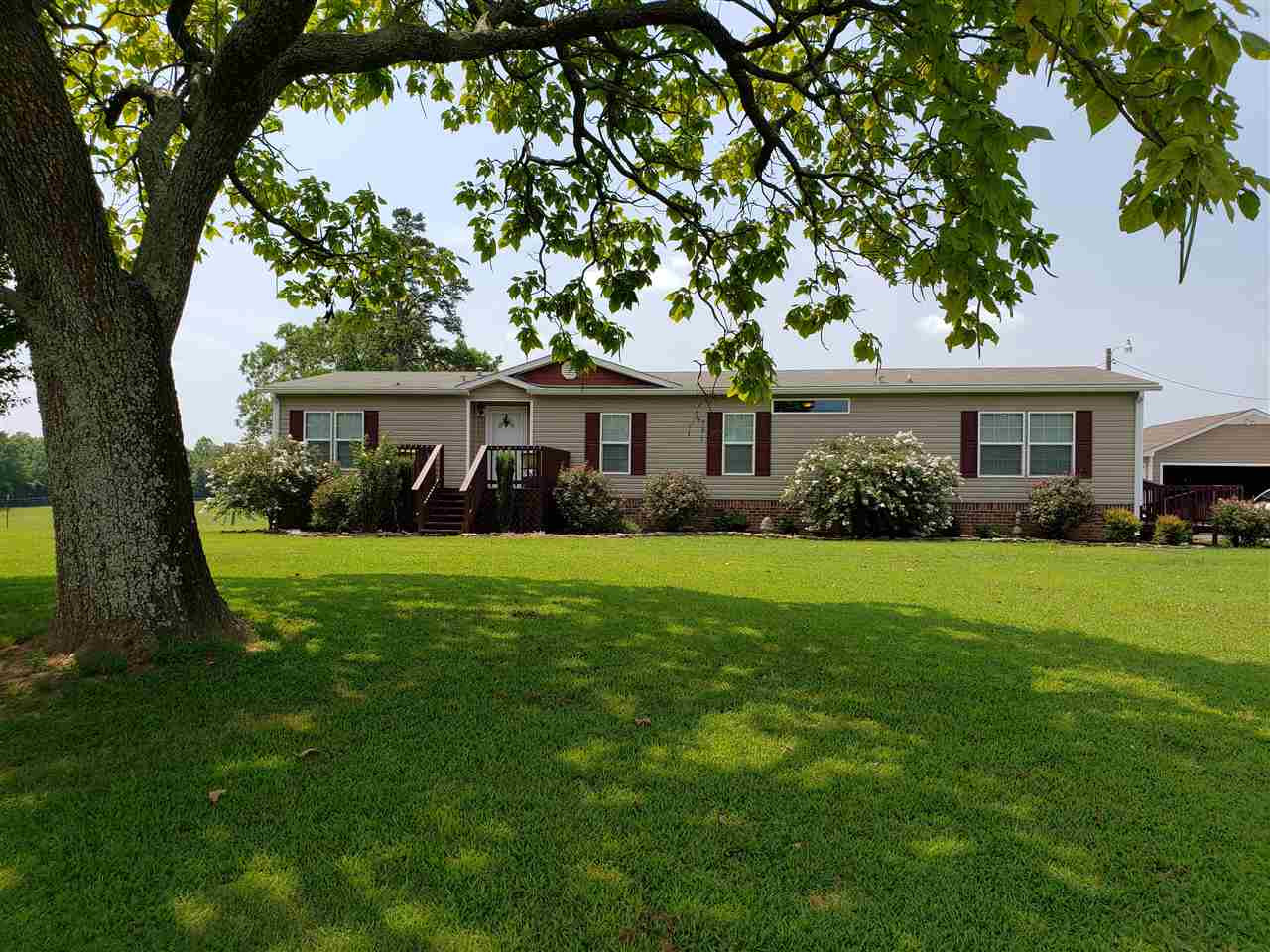 4561 Middlefork Road Luray, TN 38352 - Photo 1 of 1 a front view of a house with a yard deck and green space