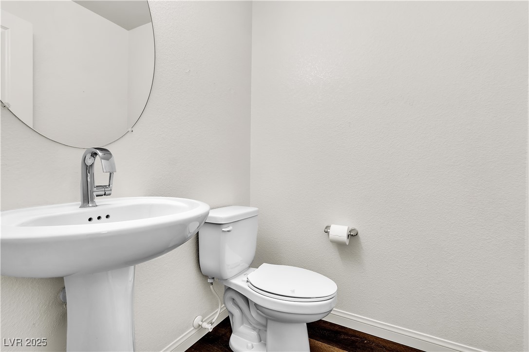 6952 Crescent Gold Street North Las Vegas, NV 89086 - Photo 25 of 58 Bathroom with baseboards, toilet, wood finished fl