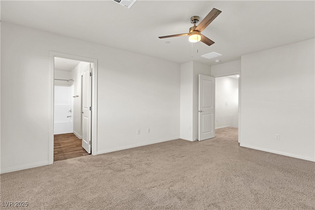 6952 Crescent Gold Street North Las Vegas, NV 89086 - Photo 30 of 58 Spare room with carpet floors, ceiling fan, and ba