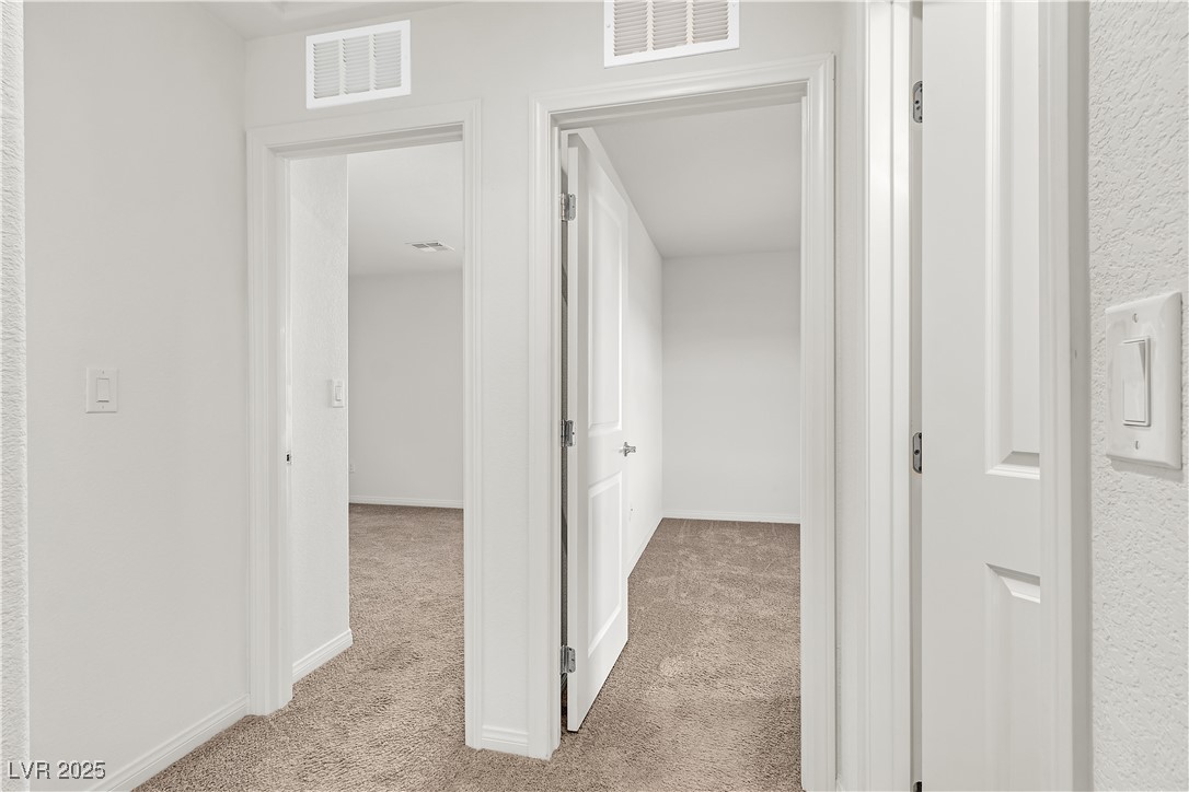6952 Crescent Gold Street North Las Vegas, NV 89086 - Photo 33 of 58 Corridor featuring light carpet and baseboards
