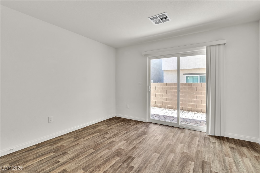6952 Crescent Gold Street North Las Vegas, NV 89086 - Photo 9 of 58 Unfurnished room featuring wood finished floors an