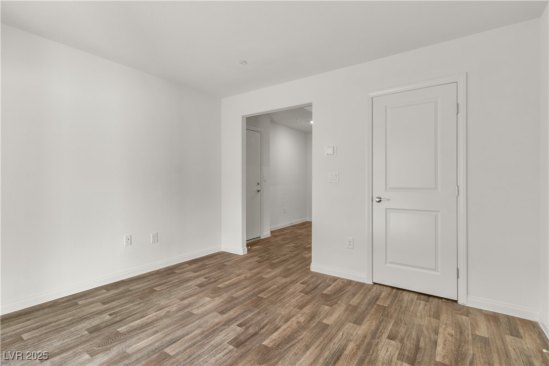 6952 Crescent Gold Street North Las Vegas, NV 89086 - Photo 10 of 58 Empty room with wood finished floors and baseboard