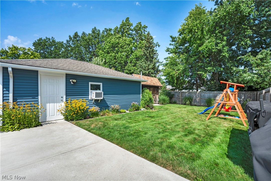 977 Lloyd Road Wickliffe, OH 44092 - Photo 35 of 38 Backyard featuring a manicured lawn, established trees, and a privacy fence
