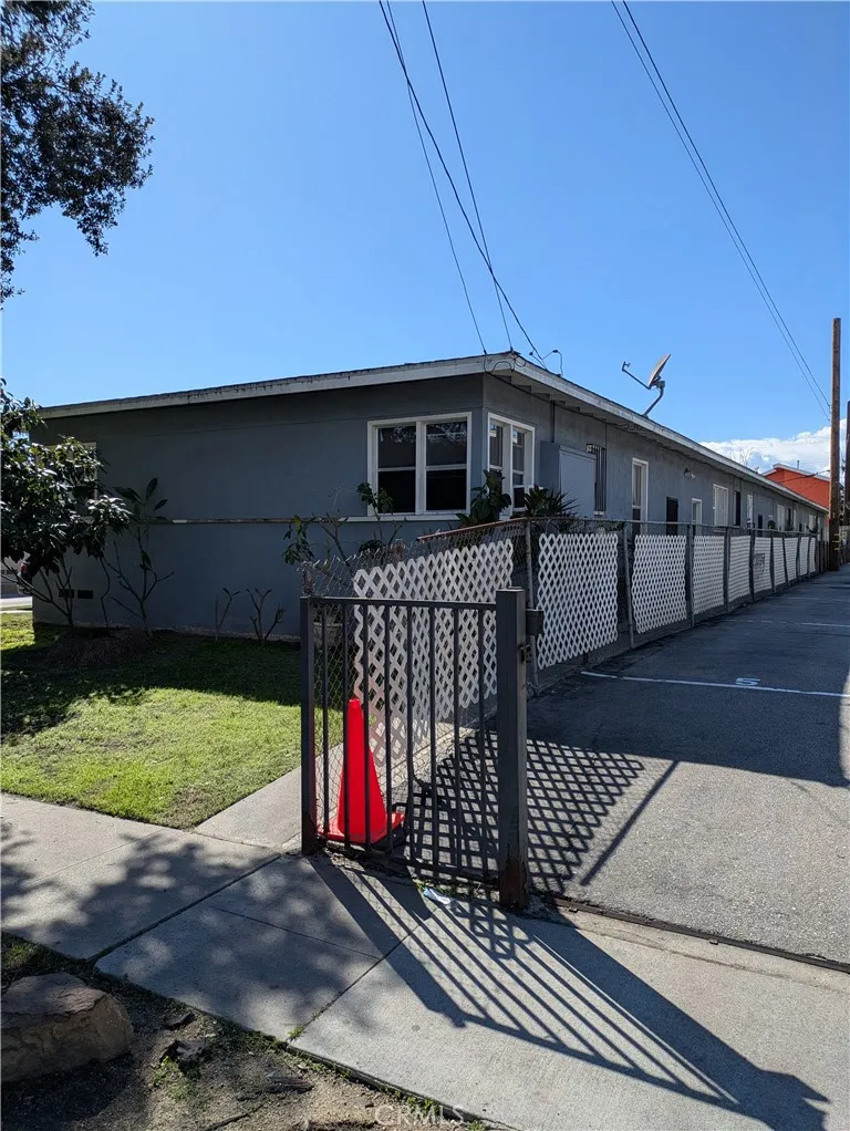 6809 Heliotrope Avenue Bell, CA 90201 - Photo 18 of 18 a view of a house with a small yard and wooden fence