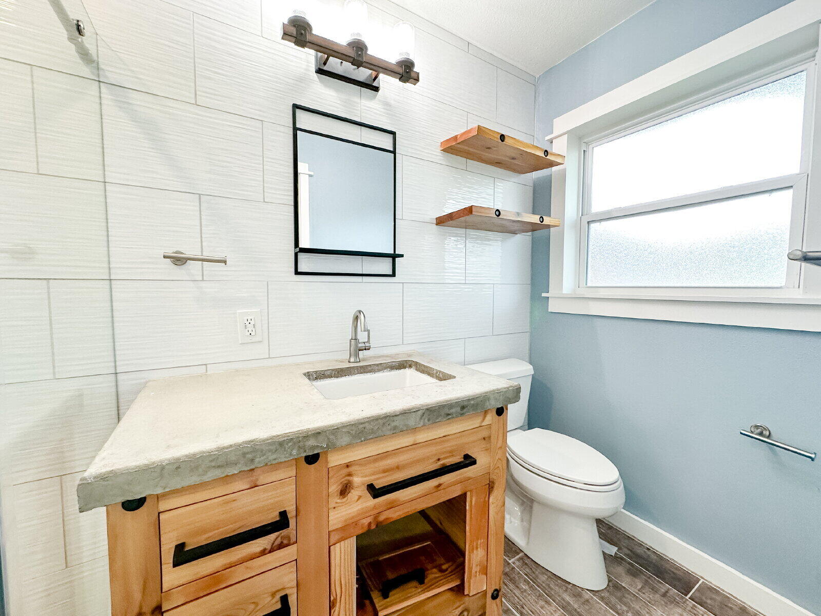 2608 Raleigh Avenue Lubbock, TX 79410 - Photo 10 of 23 a bathroom with a sink a toilet and mirror
