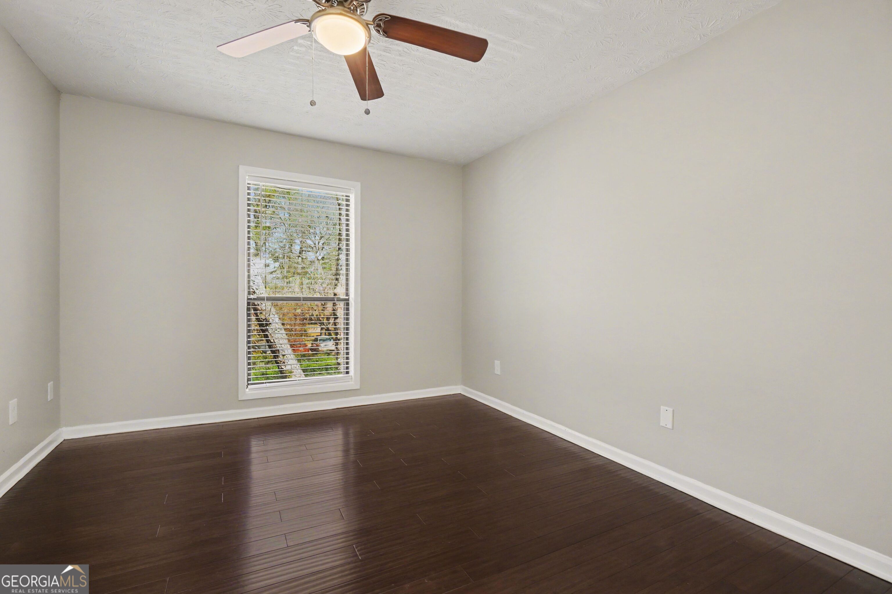 918 Dunbar Drive Atlanta, GA 30338 - Photo 8 of 16 an empty room with wooden floor chandelier fan and windows