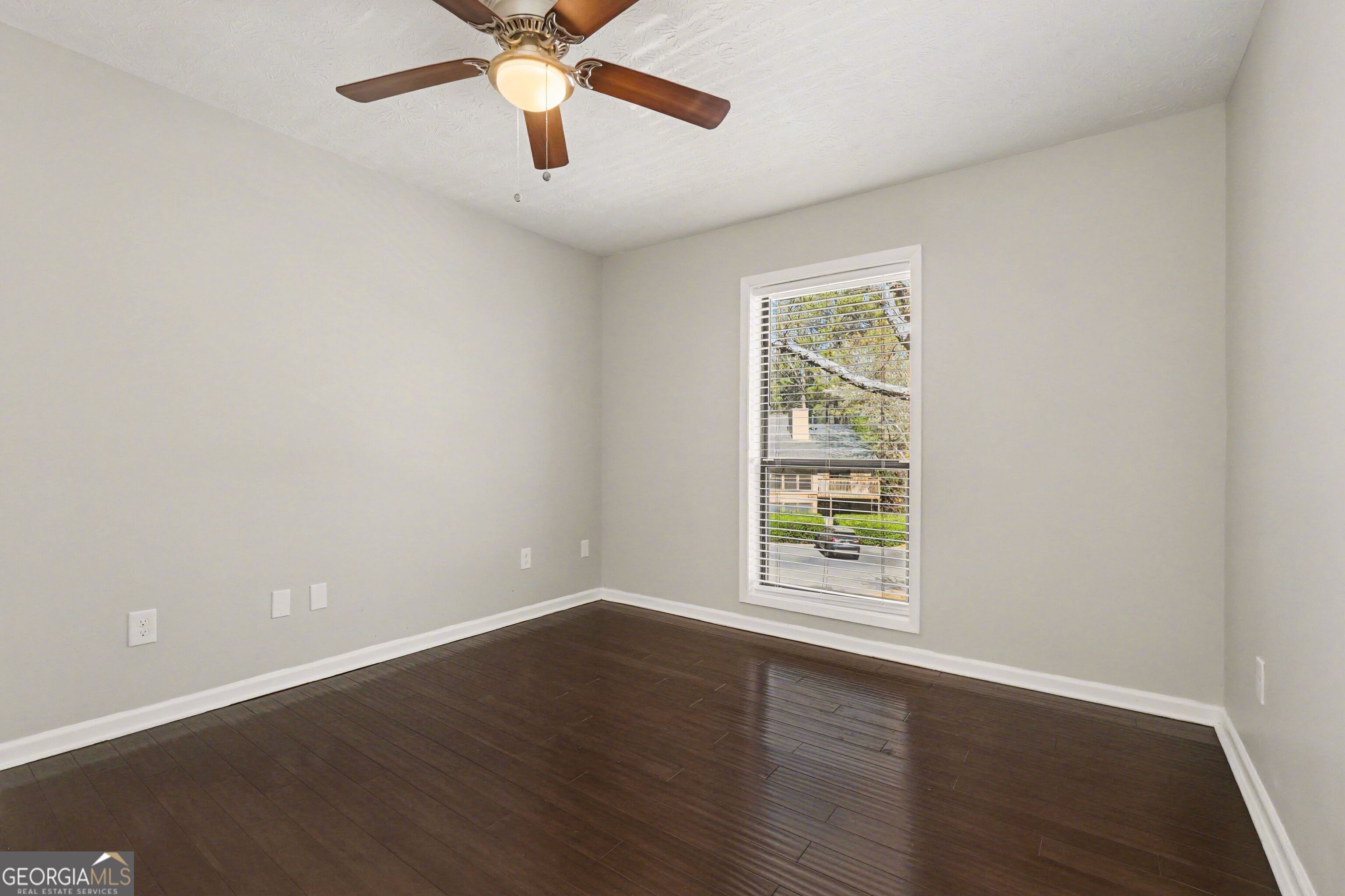 918 Dunbar Drive Atlanta, GA 30338 - Photo 9 of 16 a view of an empty room with wooden floor and a window