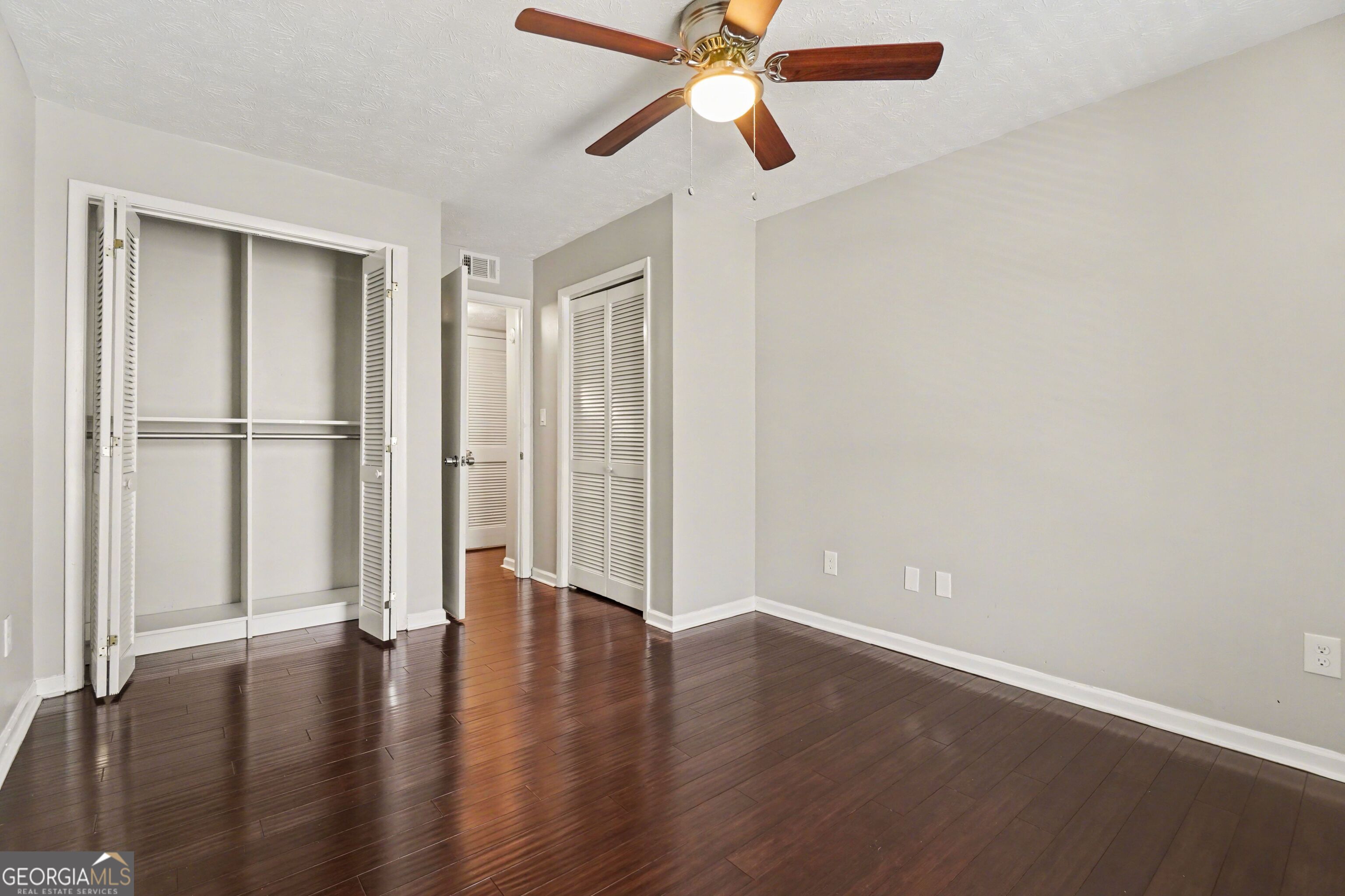918 Dunbar Drive Atlanta, GA 30338 - Photo 10 of 16 an empty room with wooden floor closet and windows
