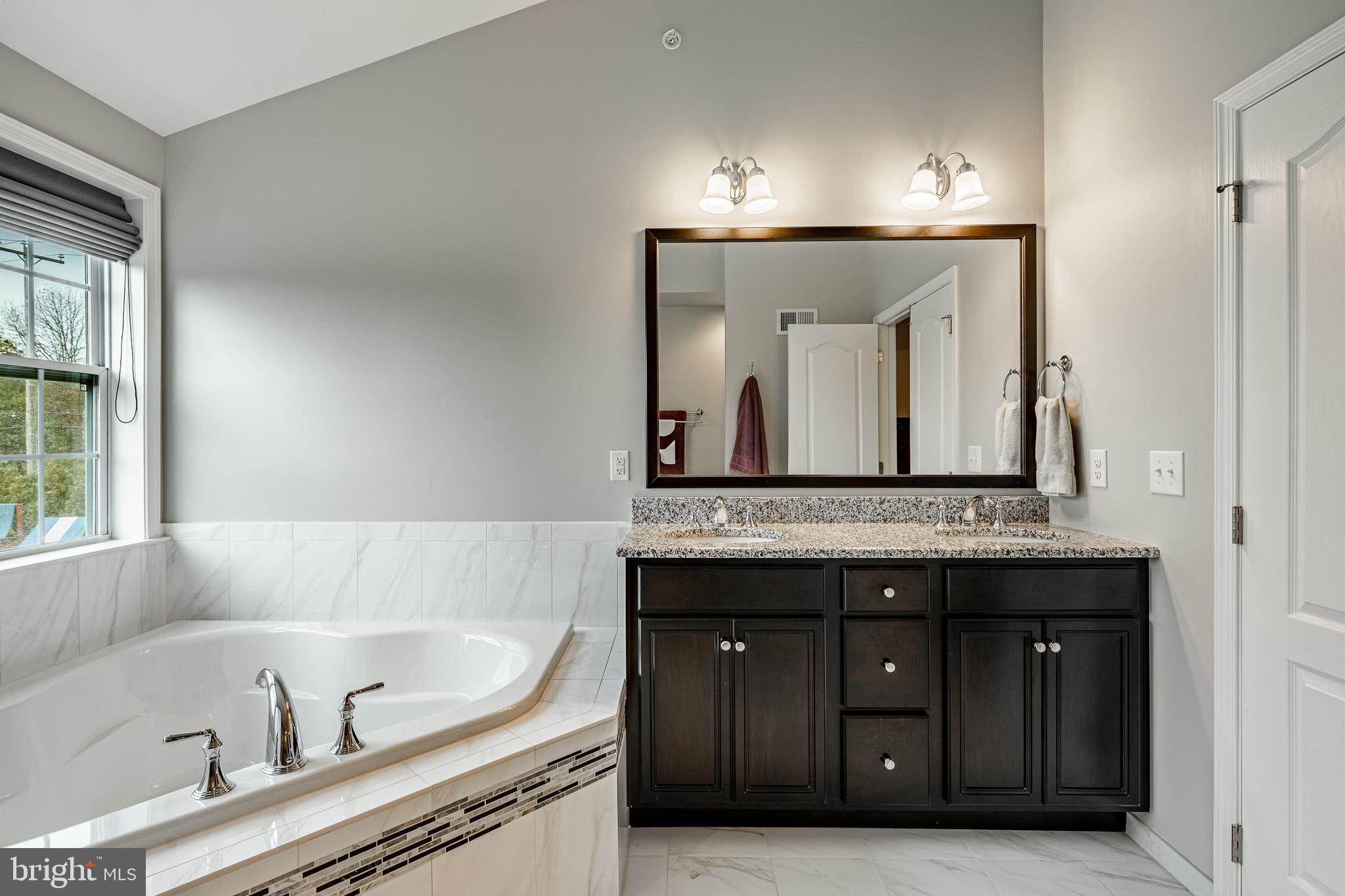 3000 Tyler Way Chalfont, PA 18914 - Photo 33 of 73 a bathroom with a tub sink and mirror