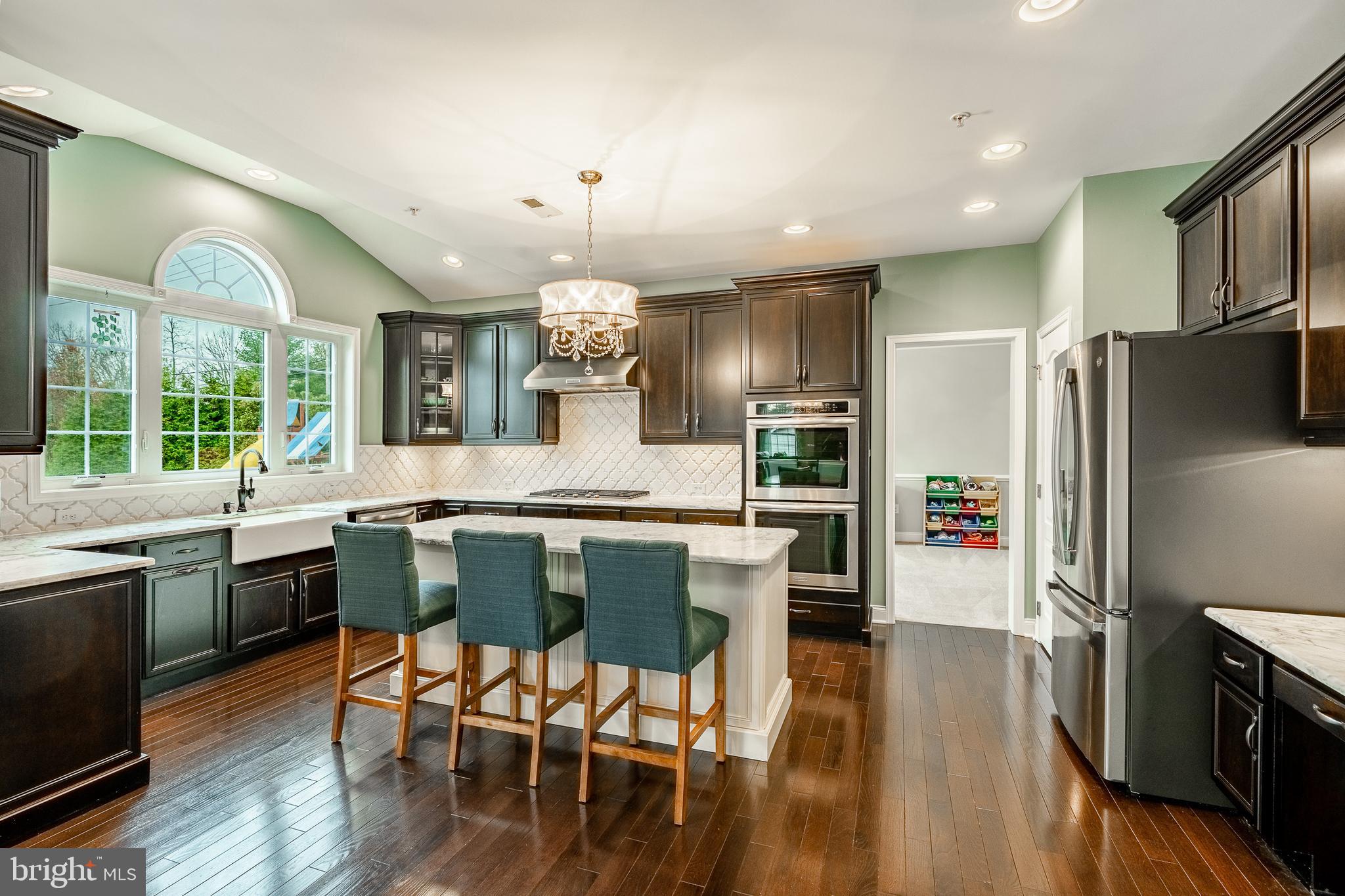 3000 Tyler Way Chalfont, PA 18914 - Photo 10 of 73 a kitchen with stainless steel appliances a dining table chairs stove refrigerator and cabinets