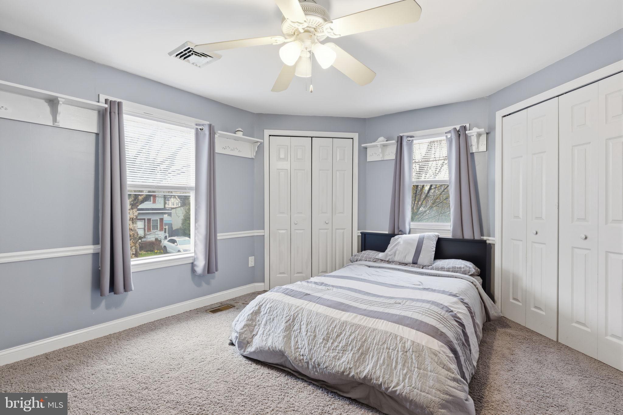 1607 Forrest Avenue Feasterville-Trevose, PA 19053 - Photo 32 of 48 a bedroom with a large bed and a chandelier fan
