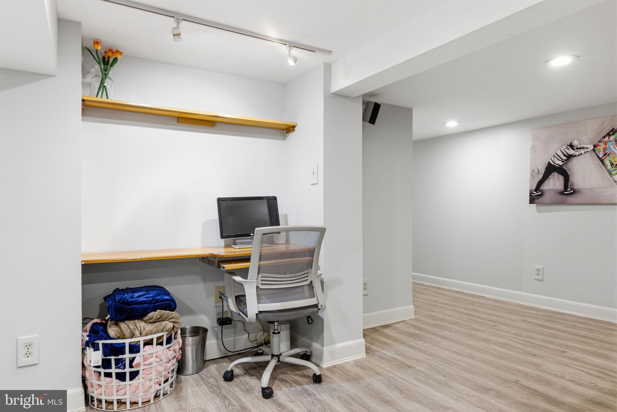 1607 Forrest Avenue Feasterville-Trevose, PA 19053 - Photo 33 of 48 a view of a workspace with furniture and wooden floor