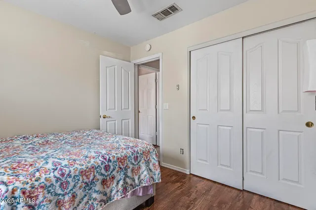 a room with a dresser and a chandelier