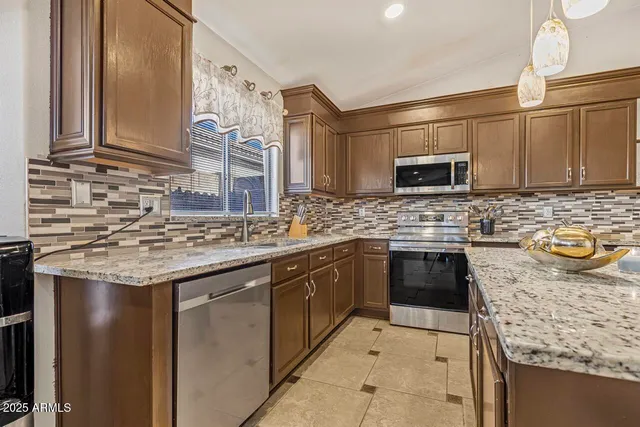 a kitchen with a sink stove and cabinets