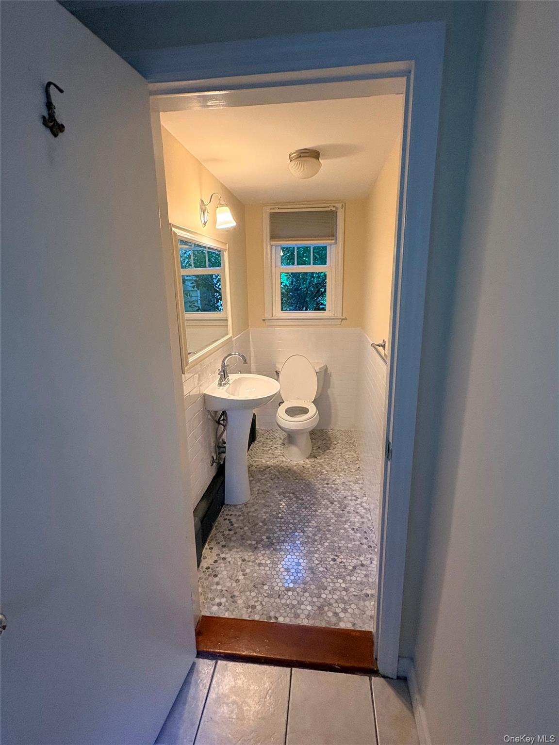 6 Tower Road Glen Cove, NY 11542 - Photo 11 of 12 a bathroom with a toilet sink and mirror
