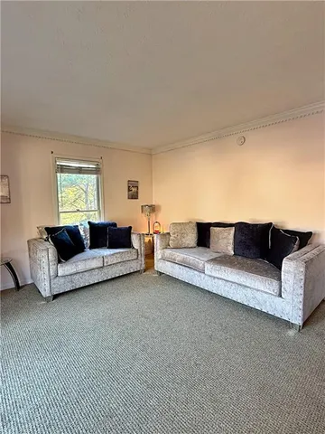 a living room with furniture flat screen tv and a fireplace