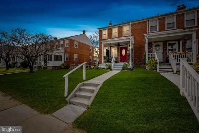 a front view of a house with a yard table and chairs